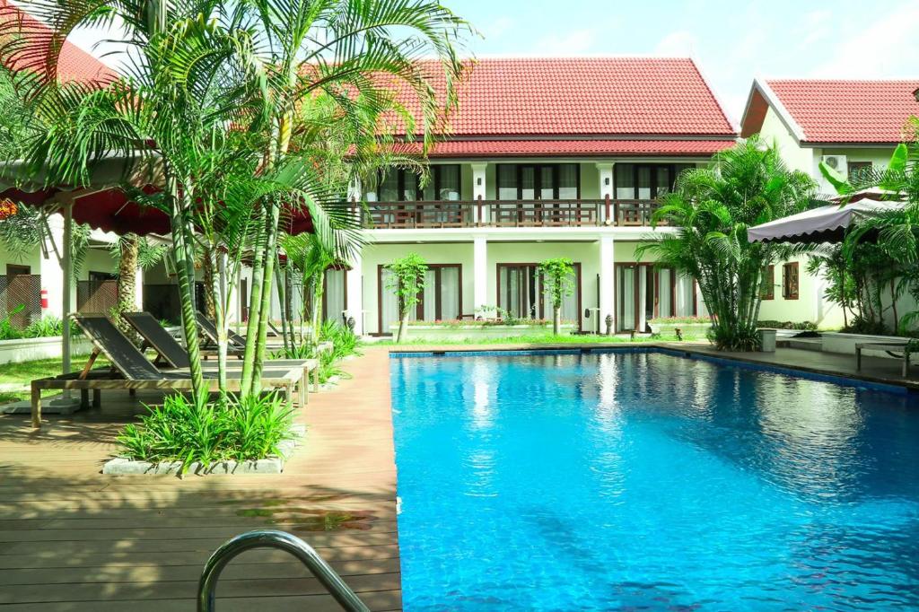 a swimming pool in front of a villa at Sunrise Garden House - Luang Prabang in Luang Prabang