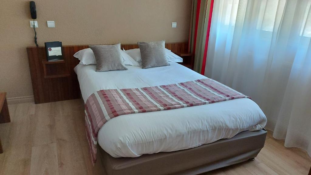 Postel nebo postele na pokoji v ubytování Hôtel Brun