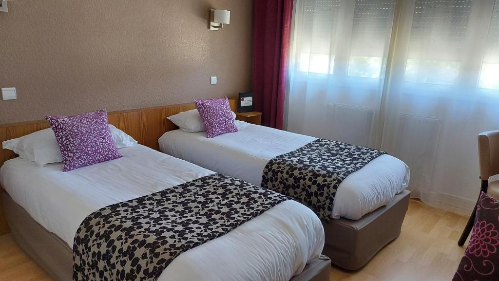 Postel nebo postele na pokoji v ubytování Hôtel Brun