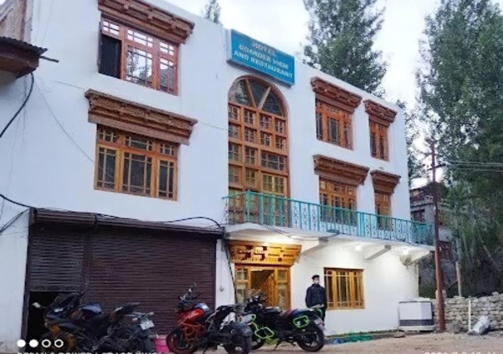 two motorcycles parked in front of a building at Hotel Border View in Kargil