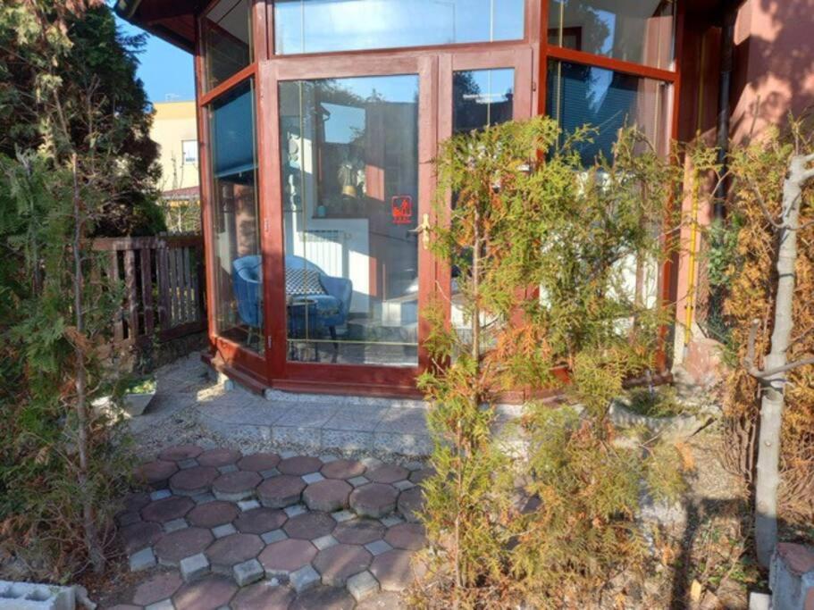 a house with a large glass door in a yard at City center, peaceful, with free parking in Varaždin