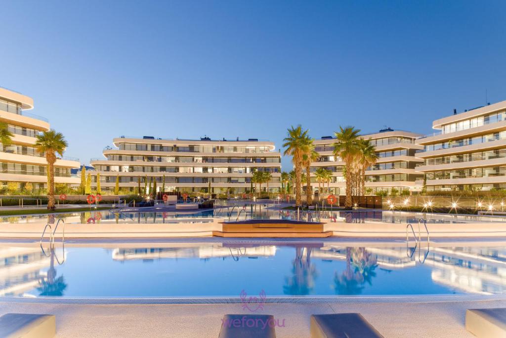 a large swimming pool in front of a building at weforyou Las Nereidas de Los Álamos 3 bedrooms and PARKING in Torremolinos