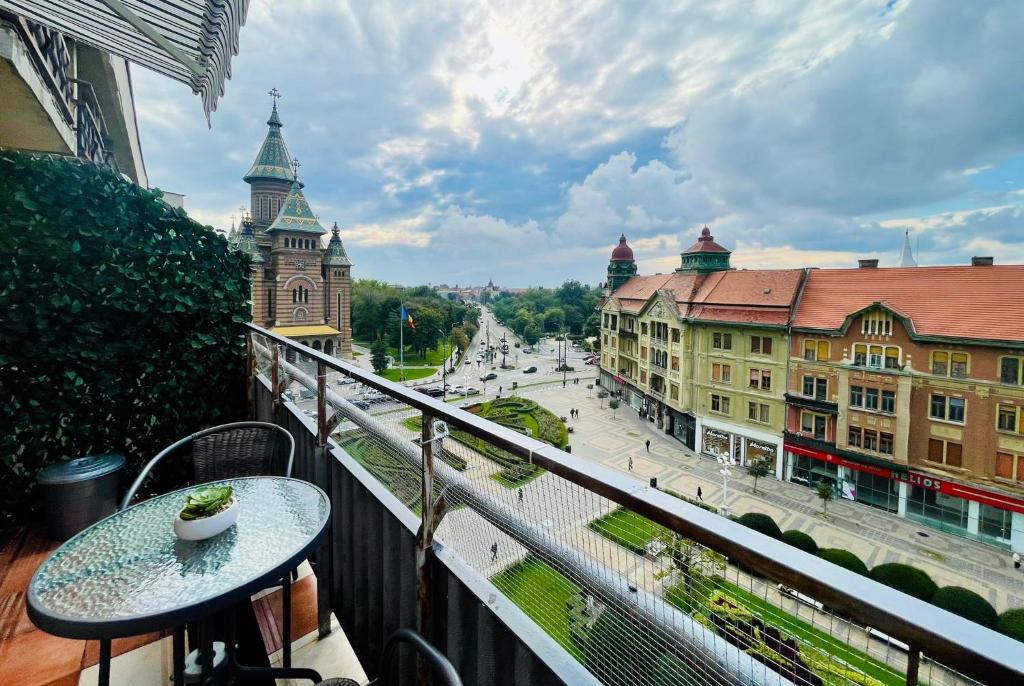a balcony with a table and a view of a city at City Center View Studio Apartment 1 in Timişoara