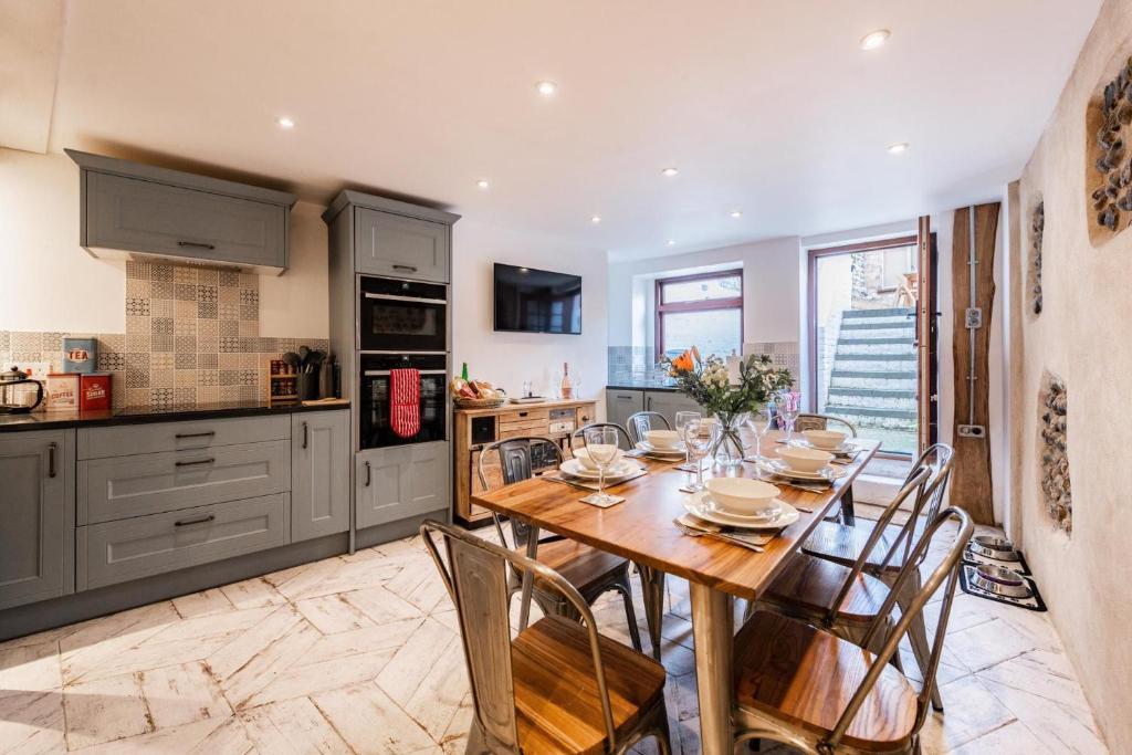 a kitchen with a wooden table and chairs at Villa Otto - Norfolk Holiday Properties in Cromer