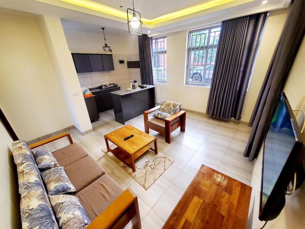 a living room with a couch and a table at Ebenezer Hotel Apartments in Kigali
