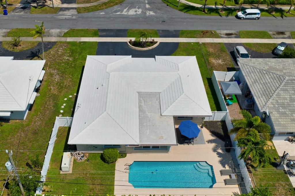 an overhead view of a large white building with a pool at Ariel Beach Cottage in Pompano Beach