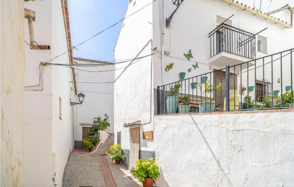 an alley with white buildings and potted plants at 1 Bedroom Lovely Home In Jubrique in Jubrique