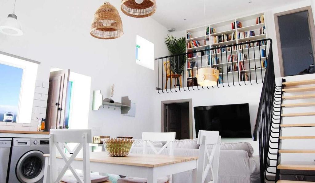 a kitchen and living room with a table and chairs at Typical Canarian house with fabulous sea views in Tías