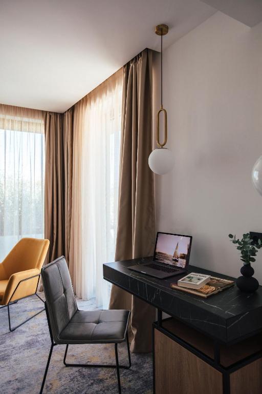 a desk with a laptop and a chair in a room at City Hotel Dubrovnik in Dubrovnik