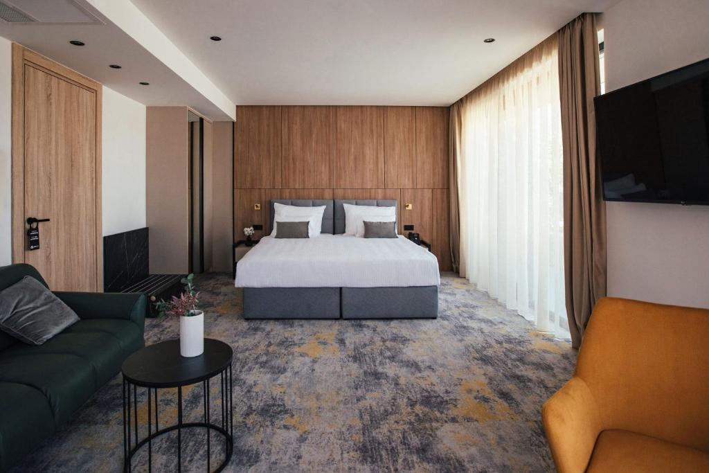 a hotel room with a bed and a couch at City Hotel Dubrovnik in Dubrovnik