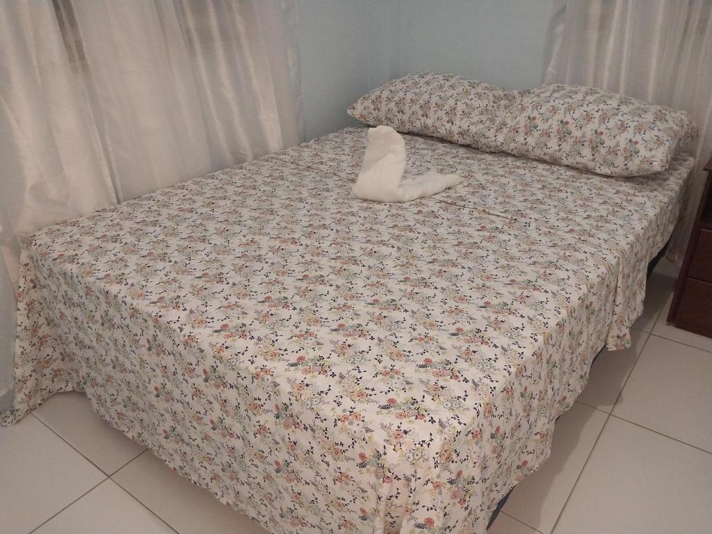 a bed with a stuffed animal sitting on top of it at Vee's Apartments SLU in Castries
