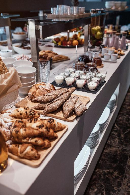 a buffet line with different types of bread and pastries at City Hotel Dubrovnik in Dubrovnik