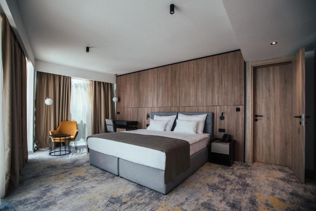 a bedroom with a large bed and a desk at City Hotel Dubrovnik in Dubrovnik