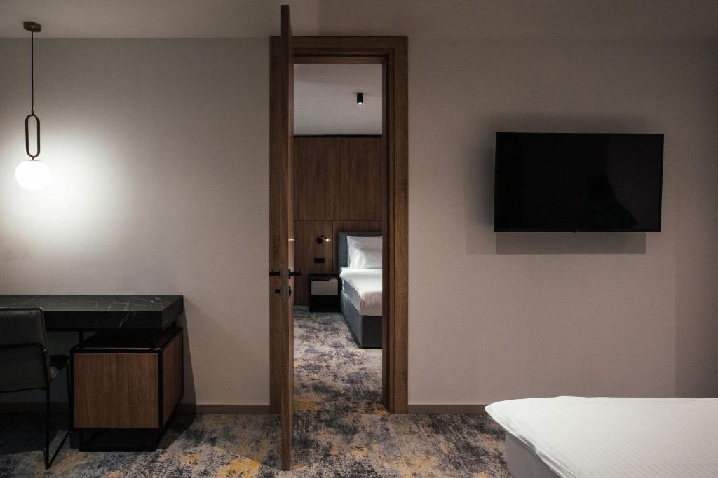 a hotel room with a bed and a television at City Hotel Dubrovnik in Dubrovnik