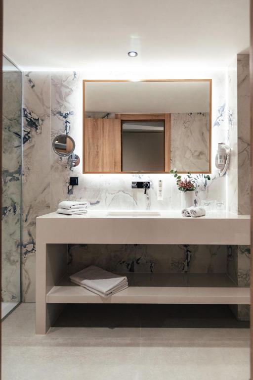 a bathroom with a sink and a mirror at City Hotel Dubrovnik in Dubrovnik