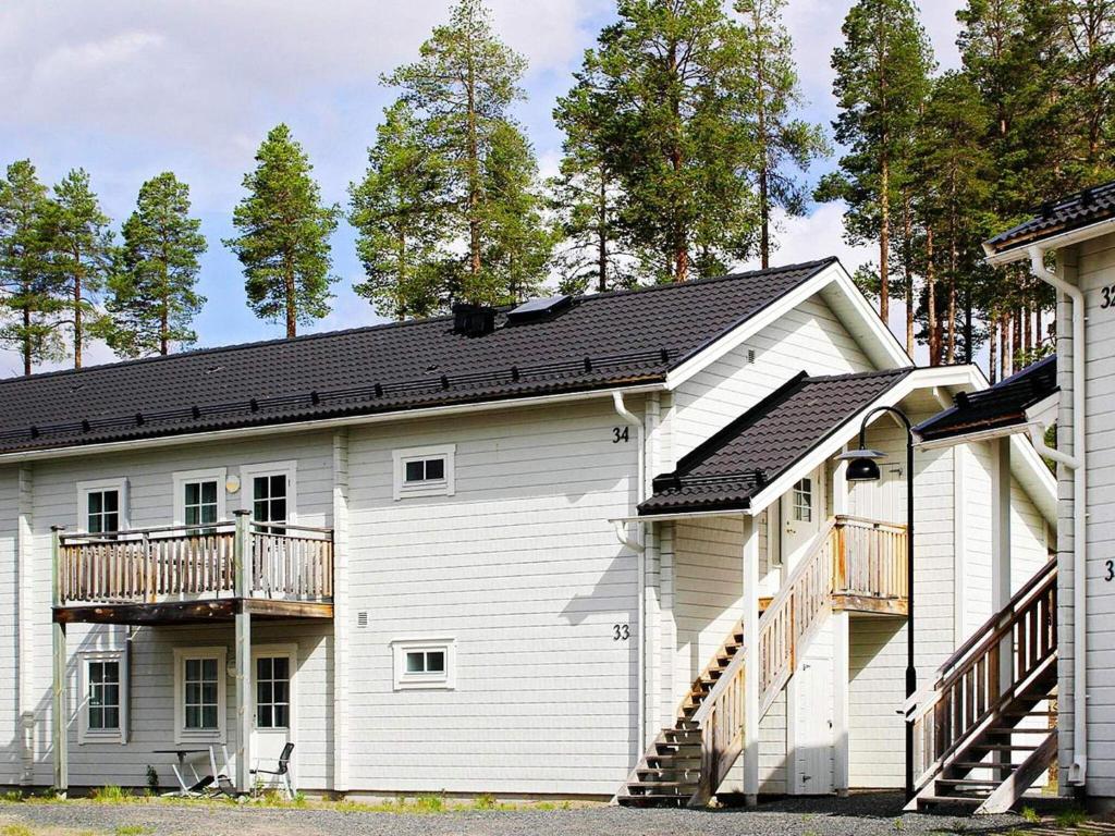 Cette maison blanche dispose d'un balcon et d'une terrasse. dans l'établissement 8 person holiday home in LOFSDALEN, à Lofsdalen