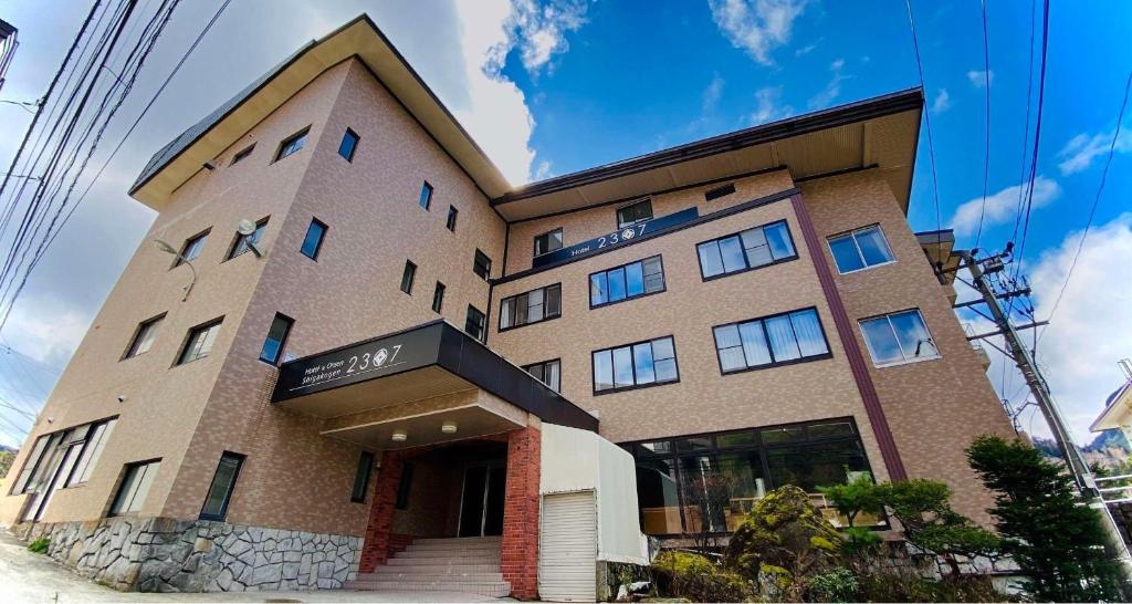 a large brick building with at Hotel & Onsen 2307 Shigakogen in Yamanouchi