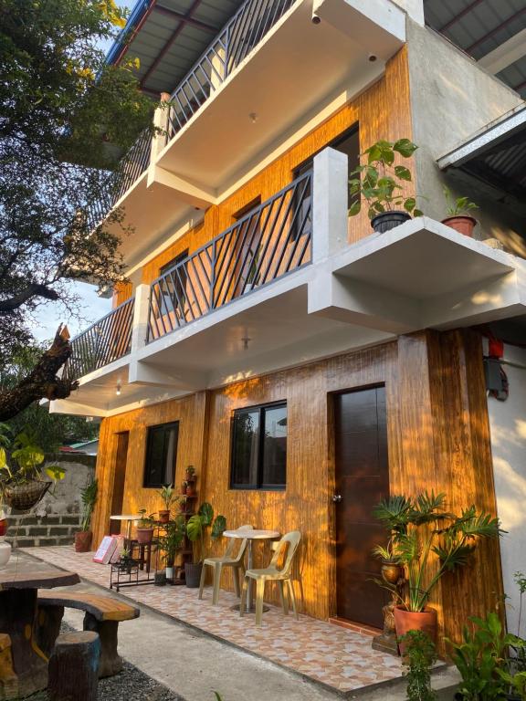 a house with a balcony and a table at Traditional Filipino Home near 100 Islands Wharf in Alaminos