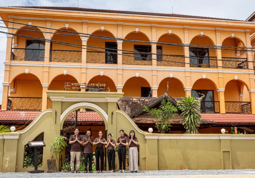 a group of people standing in front of a building at DEN HOTEL TOTONOU SIEM REAP in Siem Reap