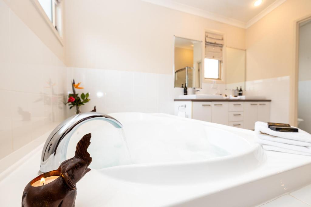 a bathroom with a statue of a rabbit on a counter at Camelot Boutique Accommodation in Mount Tamborine