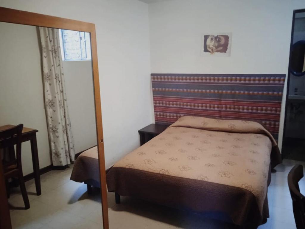 Voodi või voodid majutusasutuse Hotel Estación Central toas