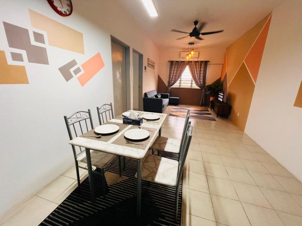 a dining table and chairs in a living room at De'Colour Stay at Country Homes Rawang in Rawang
