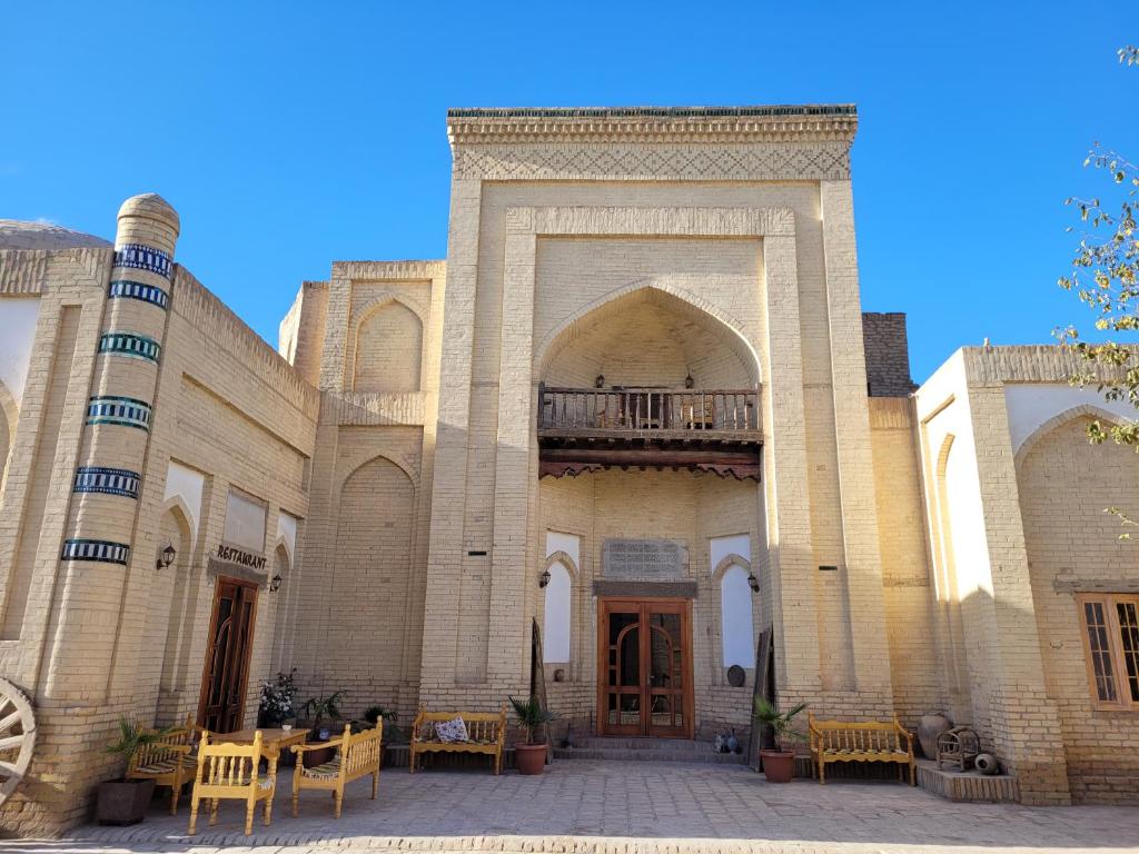 a large building with a gate and a balcony at madrasah Polvon-Qori boutique hotel in Khiva