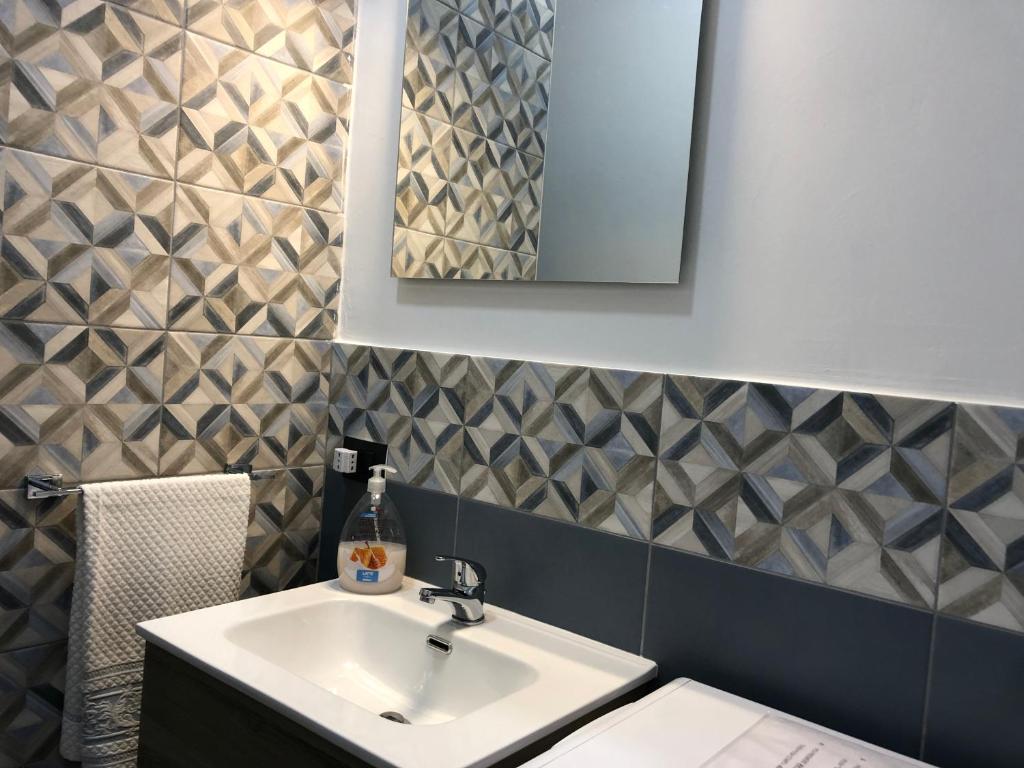 a bathroom with a sink and a mirror at La Casa di Antonella in Agrigento