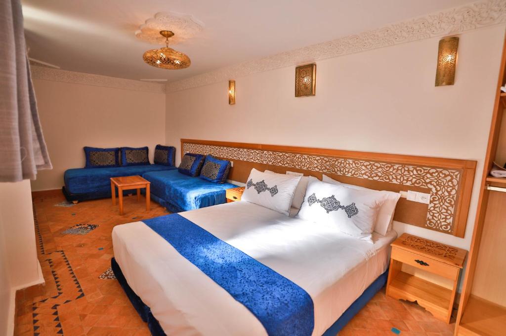 a bedroom with a large bed and a couch at Dar Kenz Fes in Fez