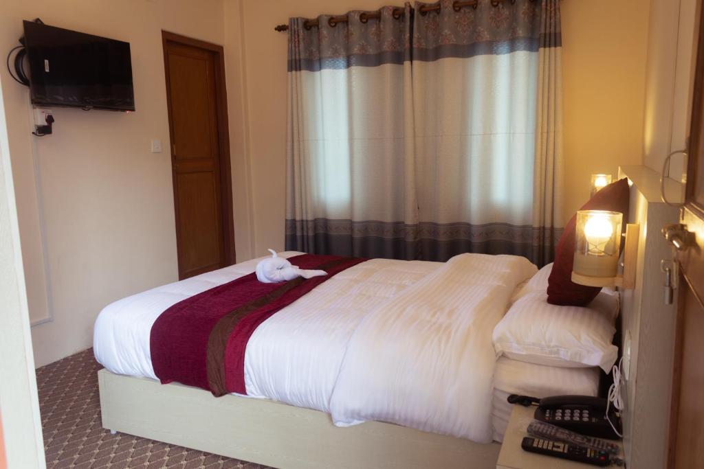 Letto o letti in una camera di Hotel New Darshan