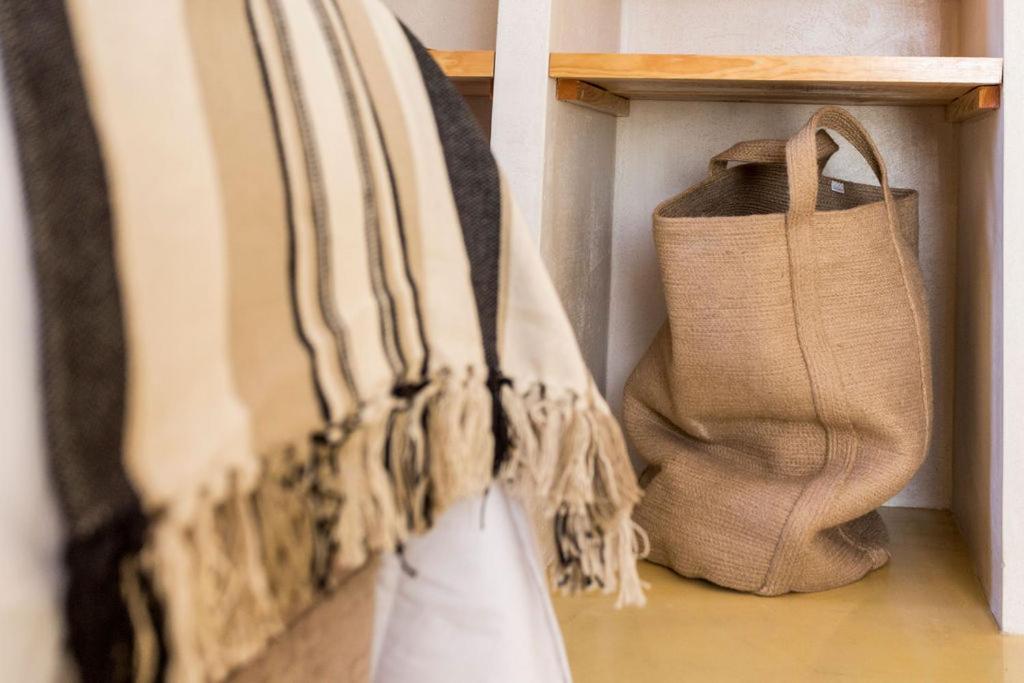 a group of bags are hanging on a shelf at Sea'Ya Thoughtful Stays - Villas in Cascais