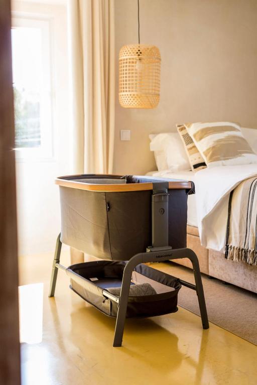 a bedroom with a bed with a table next to it at Sea'Ya Thoughtful Stays - Villas in Cascais