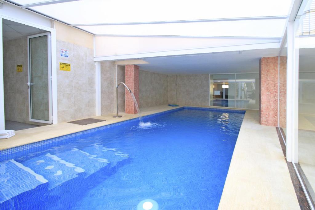 a large swimming pool in a building at Viveros Apartments in Valencia