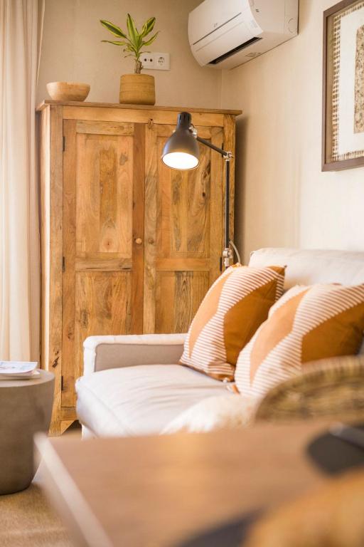 a living room with a white couch and a lamp at Sea'Ya Thoughtful Stays - Villas in Cascais