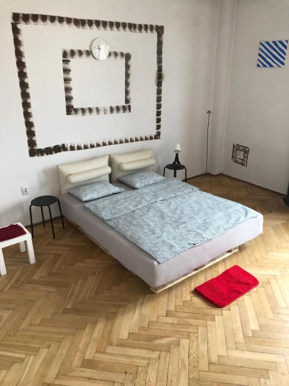 a bedroom with a bed and a wooden floor at Pokój 11A in Krakow