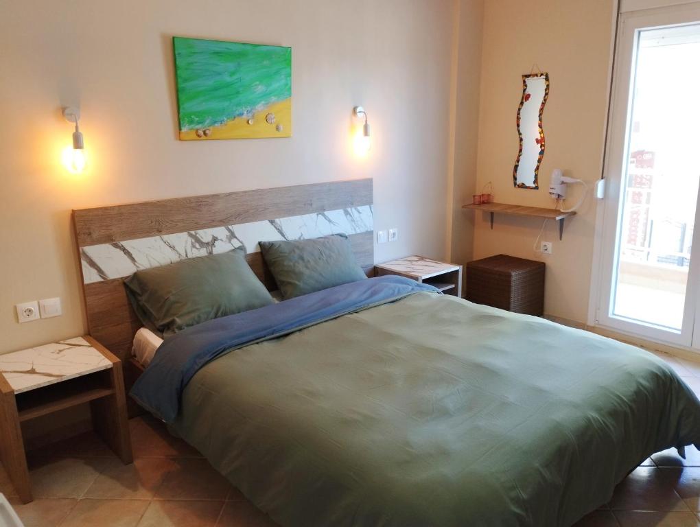 A bed or beds in a room at La MER Rooms Peraia