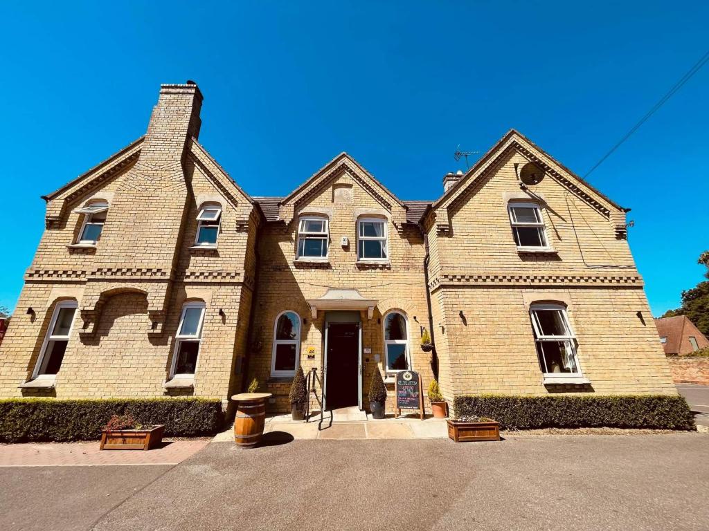 a large brick house with a door on a street at The Finch Hatton Arms in Sleaford