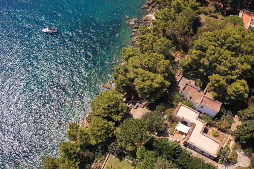 an aerial view of a house next to the water at Scopello Villa sul Mare in Scopello