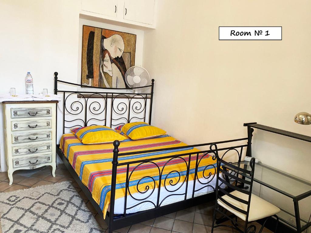 a bedroom with a bed and a painting on the wall at Nice Center Room in Nice