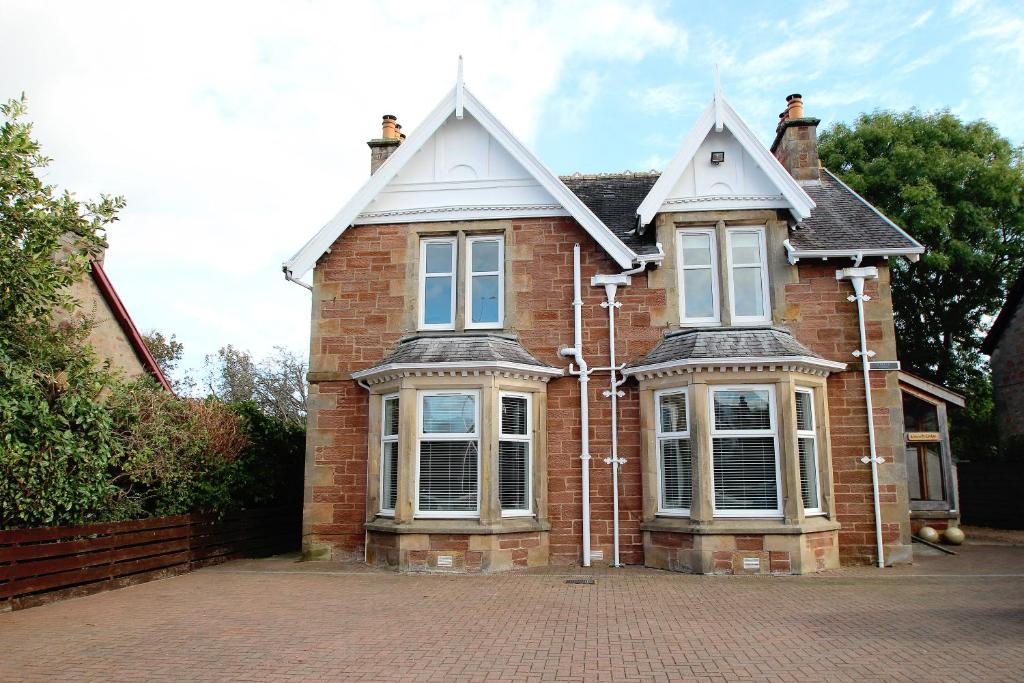 a brick house on a brick road at Kinnoch Lodge in Dalneigh