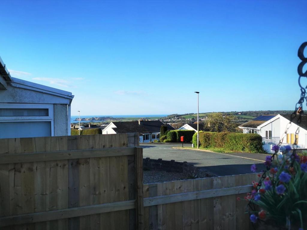 a wooden fence in front of a house at 3-Bed 5-6 berth modernised bungalow! in Tenby