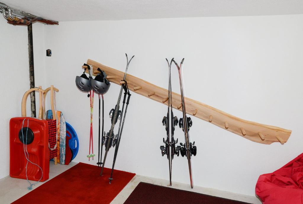 a room with skis and ski poles hanging on a wall at Fernblick Frühstückspension in Schoppernau