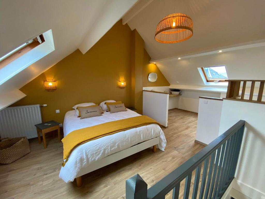 a bedroom with a bed with a yellow blanket at Gaston in Mers-les-Bains