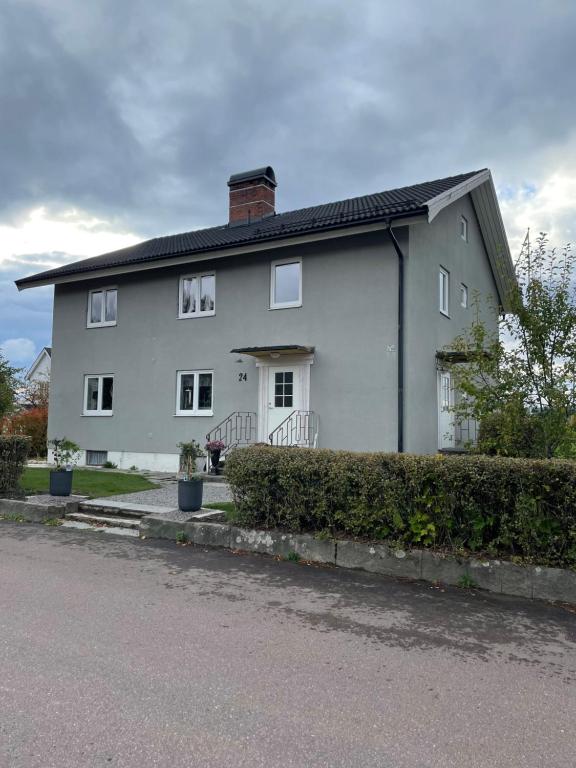 a white house with a black roof at Tingsgatan24 in Årjäng