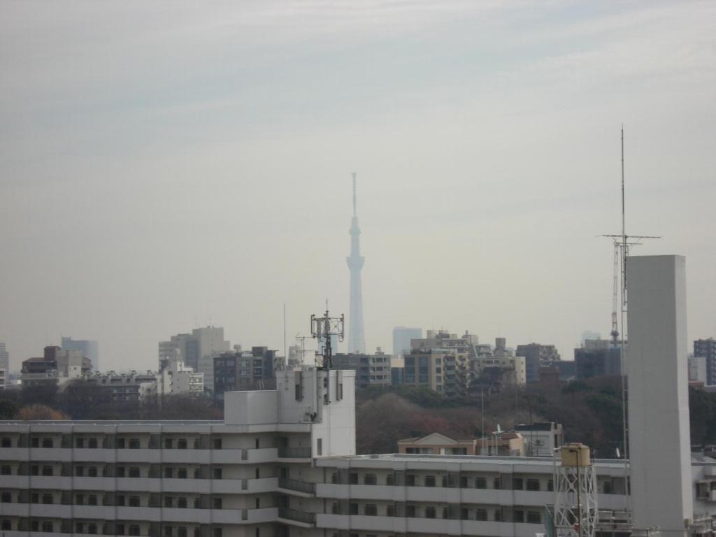 a view of a city skyline with a building at Smile Hotel Sugamo in Tokyo