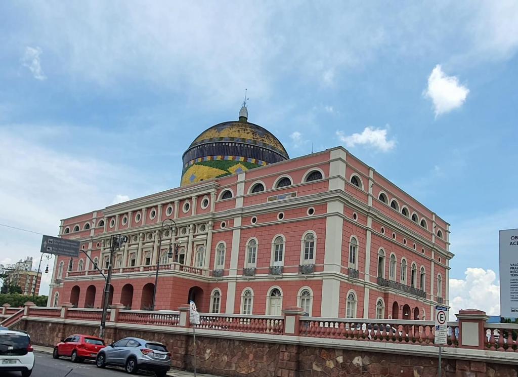 a large building with a dome on top of it at Casa 307 in Manaus