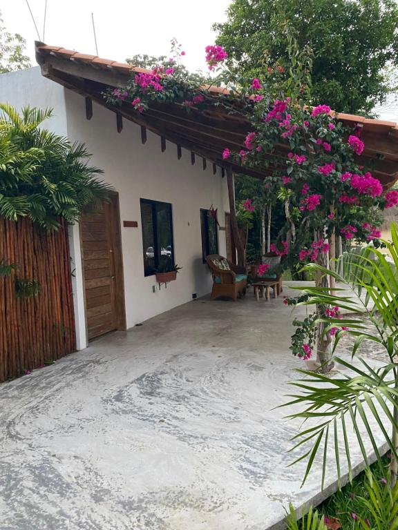 a patio of a house with pink flowers at Estancia Lapislázuli in Bacalar