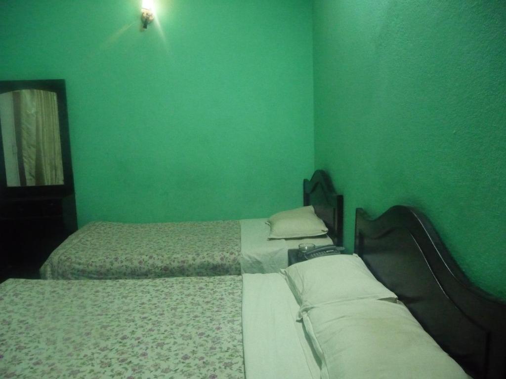 Postel nebo postele na pokoji v ubytování Pashupati Darshan Hotel