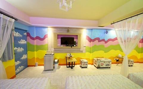 a bedroom with a bed and a colorful wall at Hi Young Castle in Hengchun South Gate