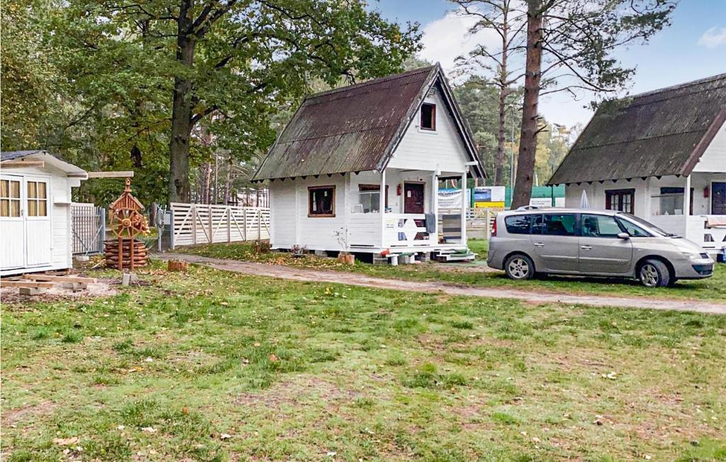 a van parked in front of a white house at 1 Bedroom Beautiful Home In Pobierowo in Pobierowo
